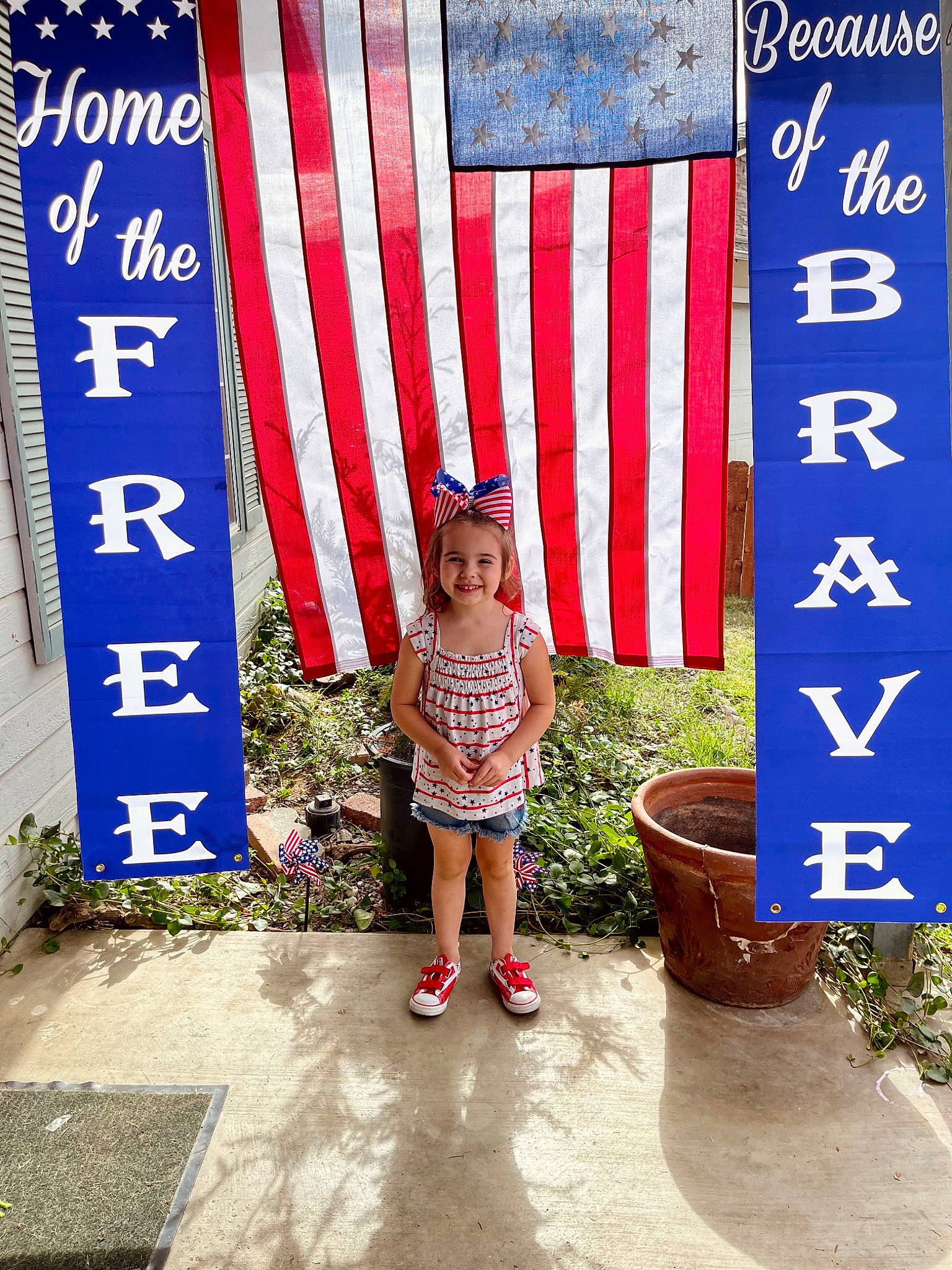 Madilynn joined the competition — help win amazing prizes! advertising, baby_toddler_clothing, beauty, child, design, flag, flag_of_the_united_states, flowerpot, font, fun, joy, leisure, magenta, pattern, person, plant, public_space, sandal, shorts, smile