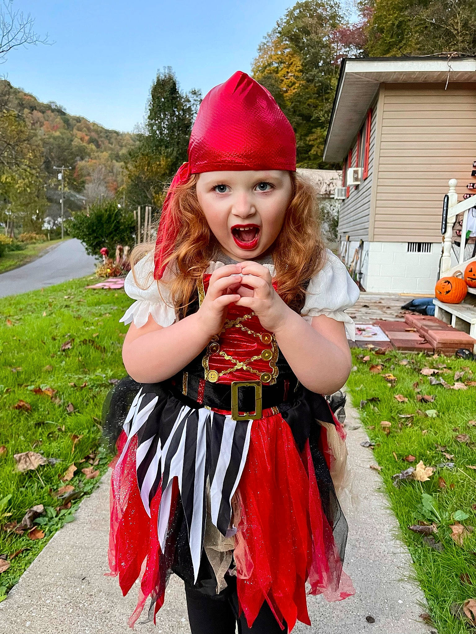 Eliza Jane is registered to the contest to win money with this photo: blond, costume, costume_hat, event, fashion_accessory, fun, grass, happy, headgear, headwear, house, magenta, pattern, person, pink, plant, recreation, sky, smile, street_fashion