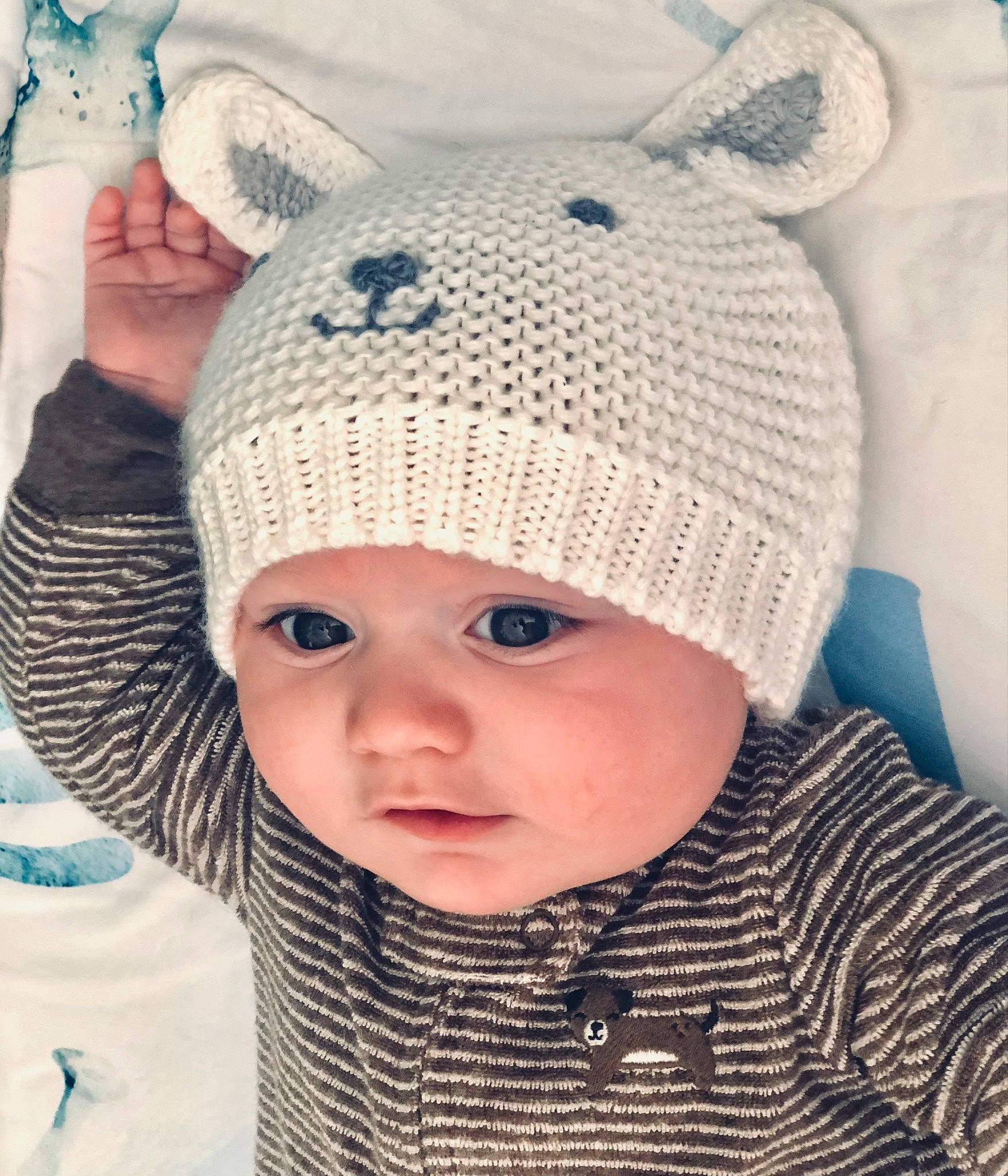 Hayven is registered to the contest to win money with this photo: baby, baby_toddler_clothing, blue, cap, cheek, clothing, creative_arts, face, happy, headgear, headwear, knit_cap, outerwear, pattern, person, product, sleeve, textile, toddler, white