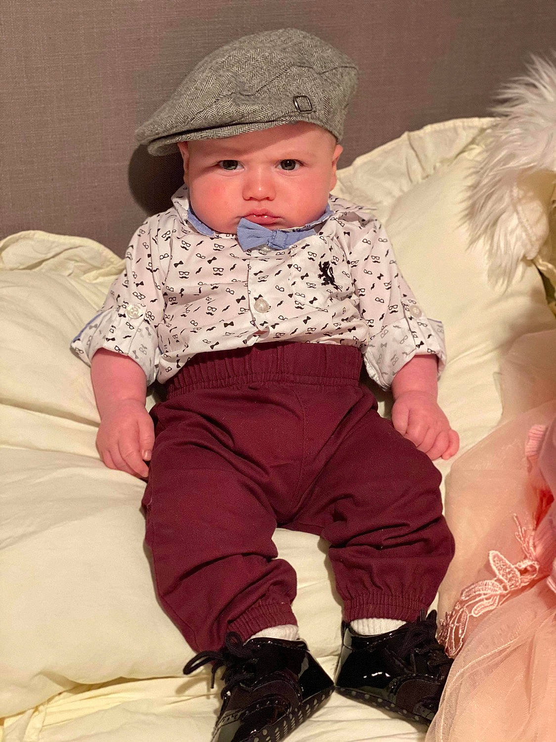 Hayven is registered to the contest to win money with this photo: baby_toddler_clothing, cap, child, comfort, costume_hat, event, fun, happy, hat, headgear, headwear, knee, lap, magenta, outerwear, person, pink, sitting, sleeve, sock