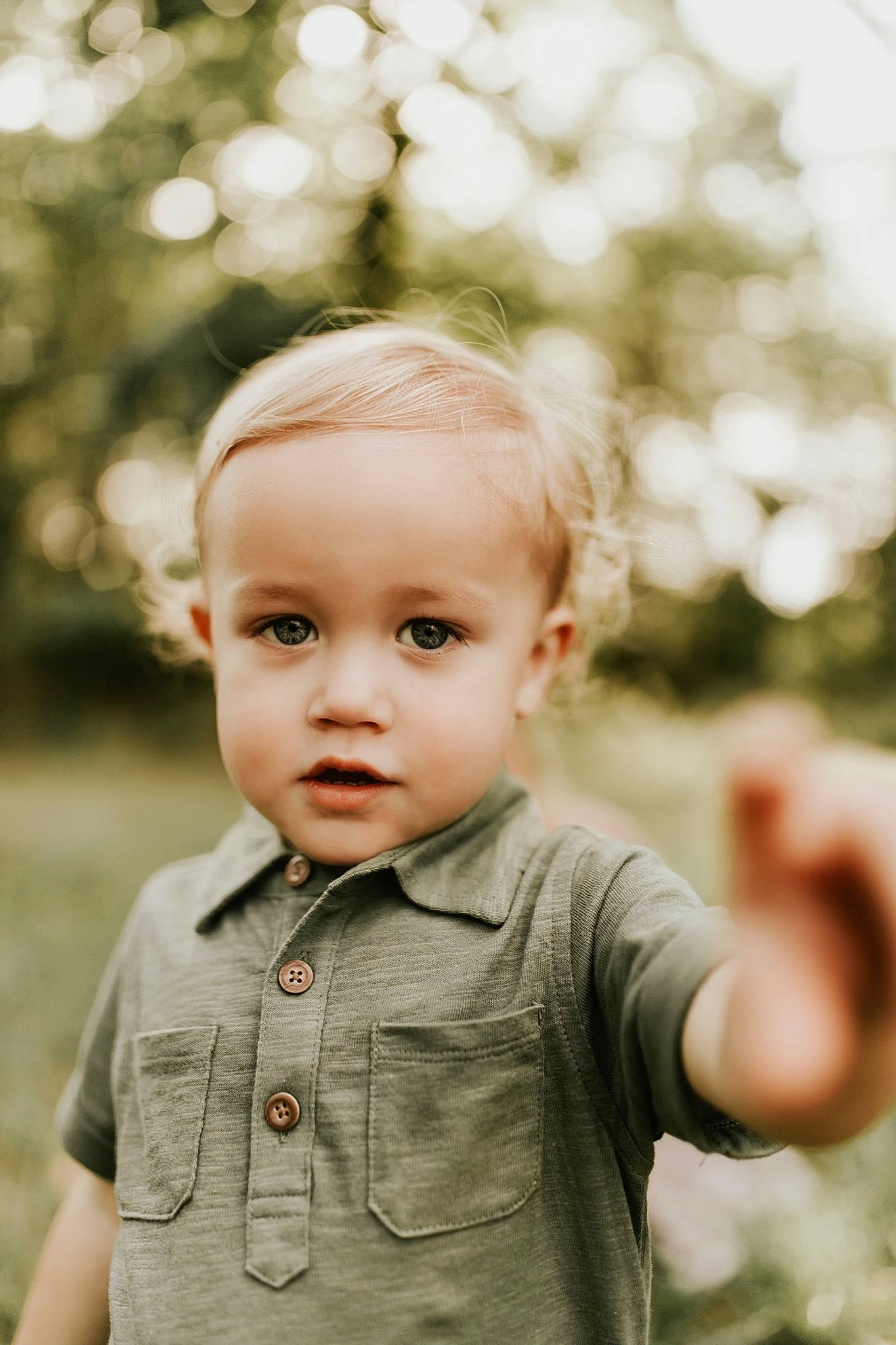 Cayton is registered to the contest to win money with this photo: baby, cheek, child, eye, face, grass, happy, head, people, person, photograph, photography, plant, portrait, portrait_photography, skin, smile, standing, toddler, tree