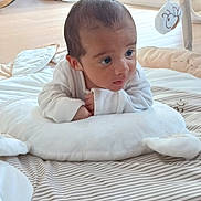 Vinnie-James joined the competition — help win amazing prizes! baby, infant, play_mat, pillow, white_clothing, indoor, floor, toy, rocking_chair, window, curious, child, soft_toys, nursery, wooden_floor, striped_pattern, cushion, face, person, early_morning_light