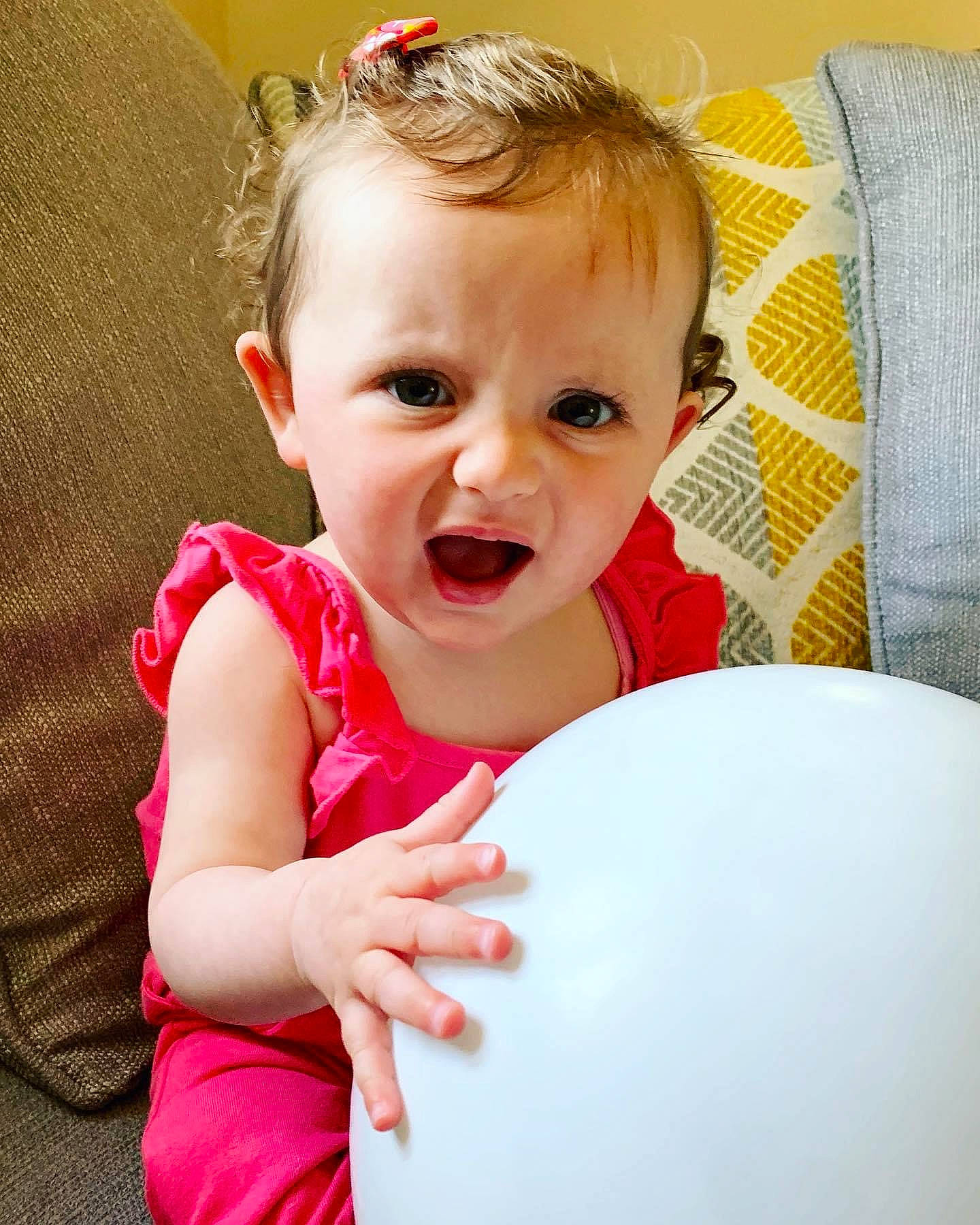 Isla-rose is registered to the contest to win money with this photo: baby, cheek, child, face, facial_expression, fun, happy, person, play, red, sitting, skin, smile, toddler