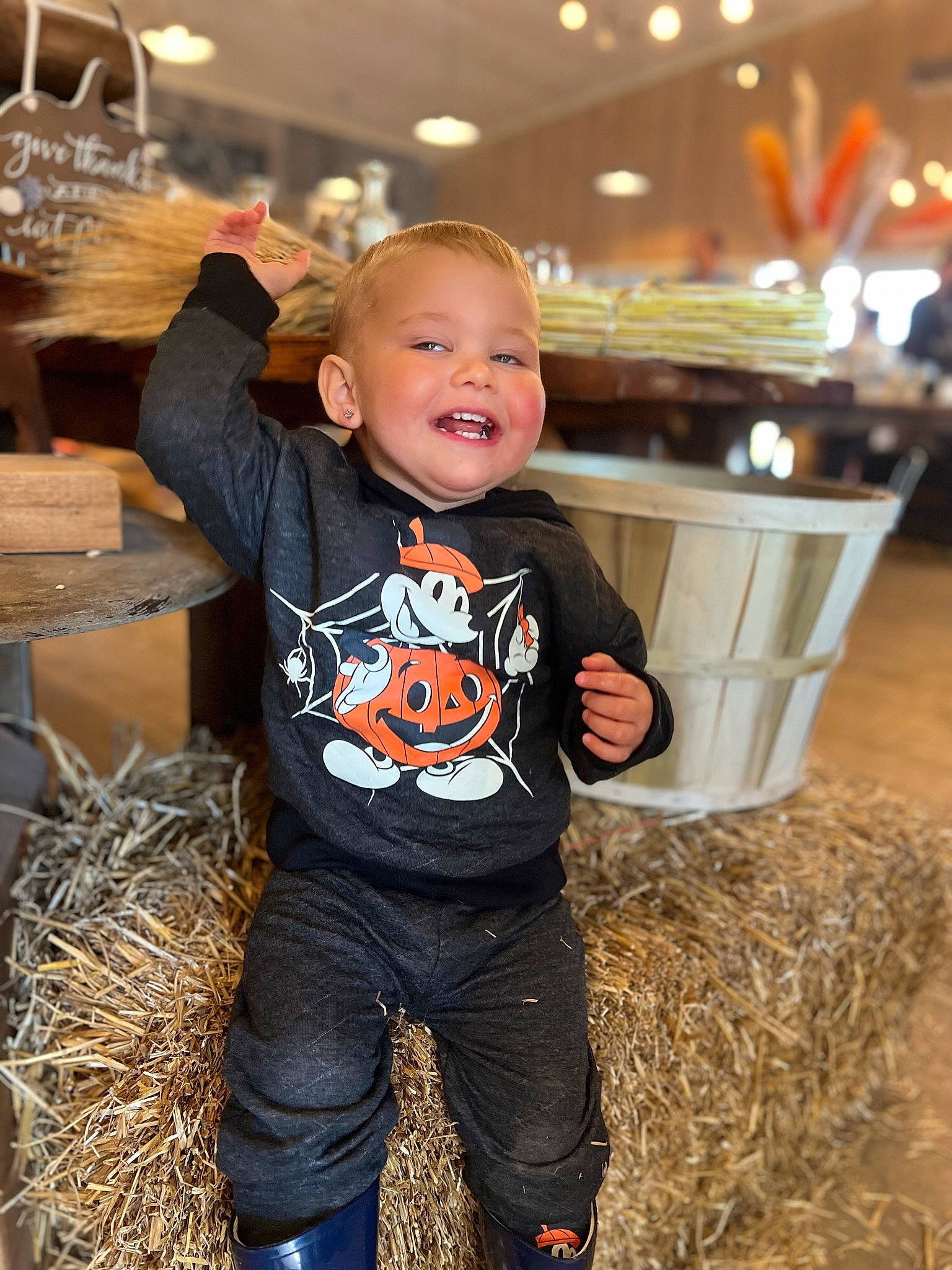Conner is registered to the contest to win money with this photo: baby, baby_toddler_clothing, child, denim, event, flash_photography, flooring, fun, grass, happy, hay, mammal, person, pumpkin, sitting, sleeve, smile, standing, t_shirt, toddler
