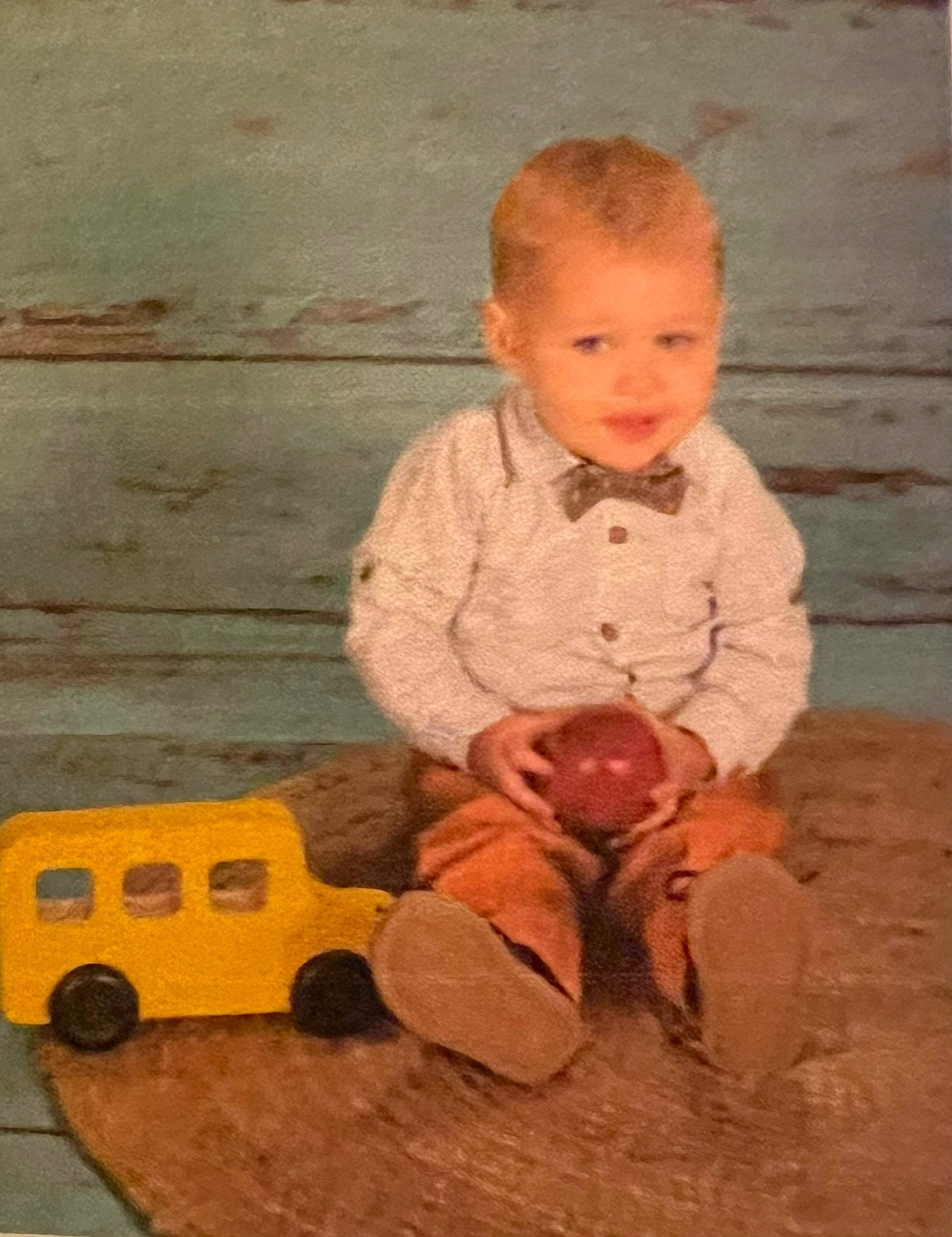 Conner is registered to the contest to win money with this photo: art, baby, baby_toddler_clothing, cheek, child, flooring, foot, fun, happy, hardwood, knee, leg, person, play, room, sitting, smile, toddler, toy, vintage_clothing