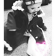 Harper is registered to the contest to win money with this photo: toddler, child, pacifier, headband, coat, carpet, floor, indoor, black_and_white, cute, sitting, baby, clothing, portrait, infant, warm_clothing, furniture, cozy, young_child, heart_glow