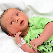 Logan is registered to the contest to win money with this photo: architecture, arm, baby, bodypart, building, clothing, crying, face, finger, glove, hand, head, hospital, newborn, person, photography, portrait, sad, t_shirt, wrist