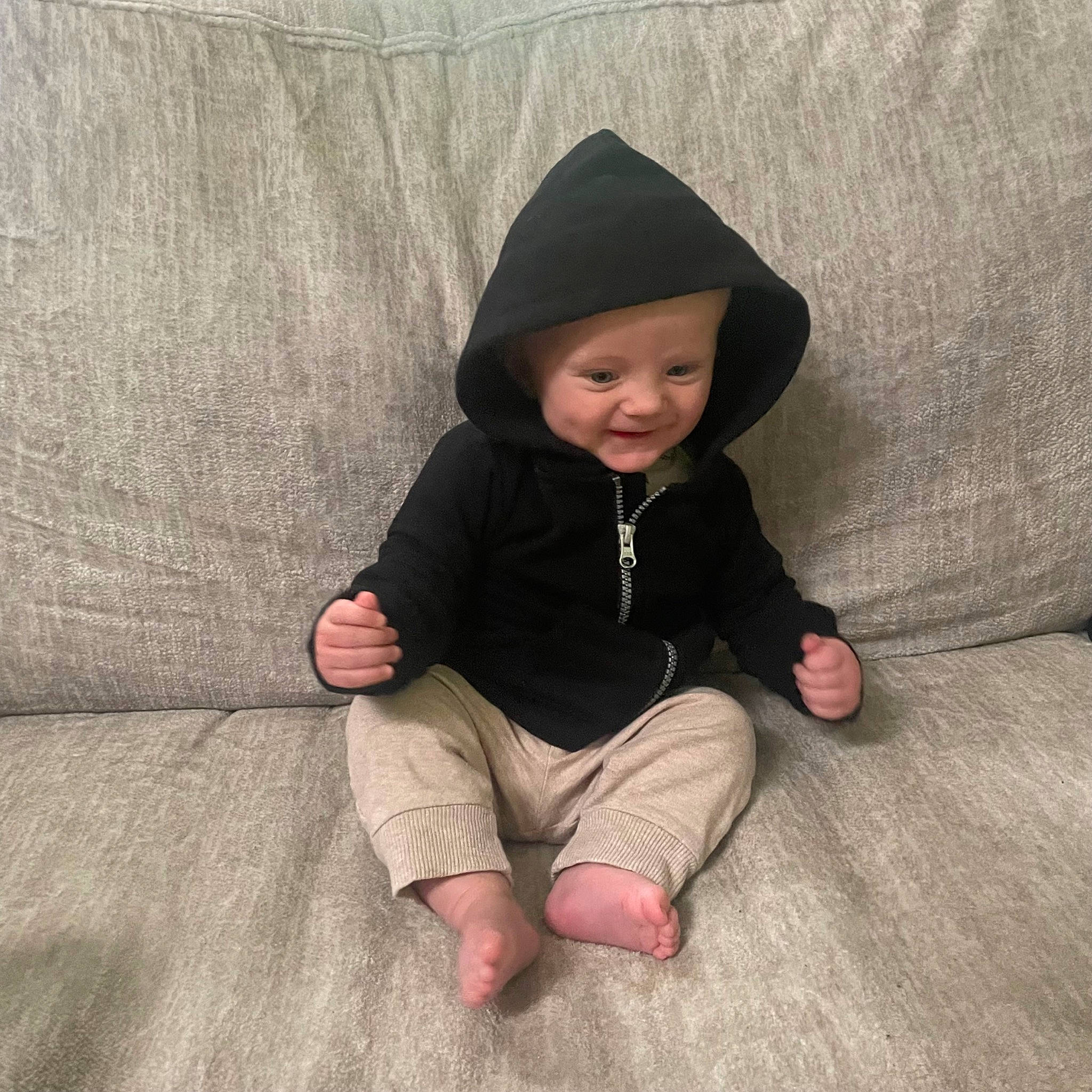 Emmett joined the competition — help win amazing prizes! baby, baby_toddler_clothing, cap, child, comfort, eye, face, fashion_accessory, flooring, foot, fun, head, headwear, linens, person, sitting, sleeve, smile, textile, toddler