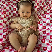 Gemma joined the competition — help win amazing prizes! baby, infant, child, cute, heart_pattern, blanket, clothing, headband, legs, feet, hands, portrait, indoors, young_child, sitting, fabric, pattern, soft_lighting, skin, expression