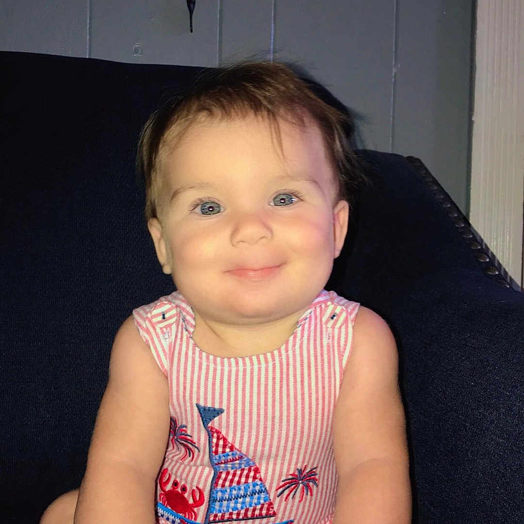 Callum is registered to the contest to win money with this photo: baby, barefoot, blue_eyes, child, chubby_cheeks, couch, crab, cute, feet, hands, happy, indoor, person, portrait, romper, sailboat, sitting, smiling, striped_clothing, wall_sconce