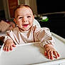 baby, child, high_chair, smile, happy, face, hands, indoor, clothing, striped, young_child, portrait, person, cute, infant, sitting, table, feeding_chair, skin, expression