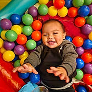 Bensyn is registered to the contest to win money with this photo: baby, ball_pit, child, clothing, colorful_balls, cute, dimples, fun, hands, happy, hoodie, indoor, infant, joyful, leisure, person, play, playground, smiling, toy
