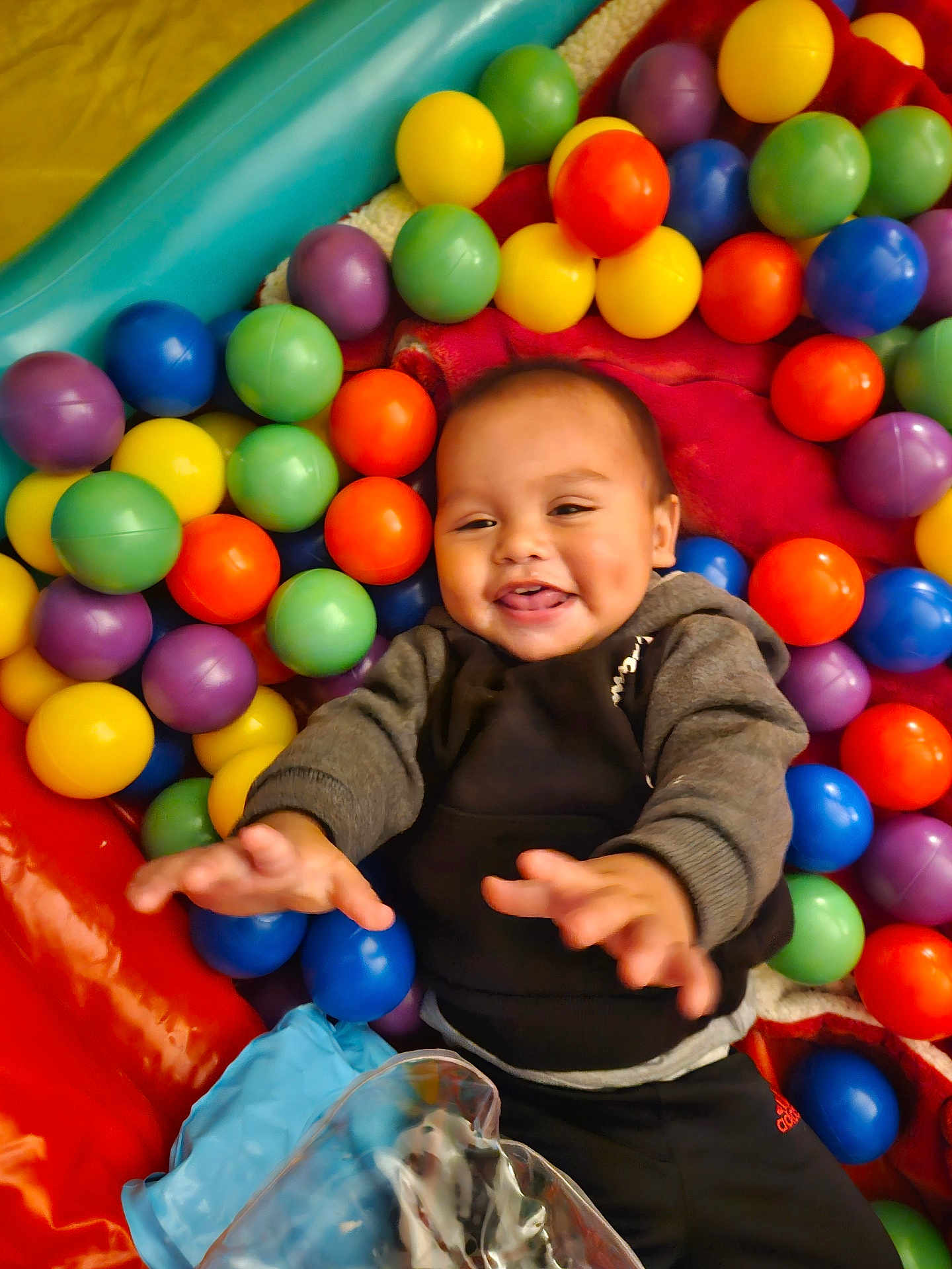 Bensyn is registered to the contest to win money with this photo: baby, ball_pit, child, clothing, colorful_balls, cute, dimples, fun, hands, happy, hoodie, indoor, infant, joyful, leisure, person, play, playground, smiling, toy