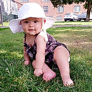 Theryn joined the competition — help win amazing prizes! baby, hat, grass, outdoor, sunlight, child, greenery, building, tree, car, sidewalk, smile, curious, summer, nature, infant, candid, cute, portrait, playful
