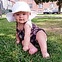 baby, hat, grass, outdoor, sunlight, child, greenery, building, tree, car, sidewalk, smile, curious, summer, nature, infant, candid, cute, portrait, playful
