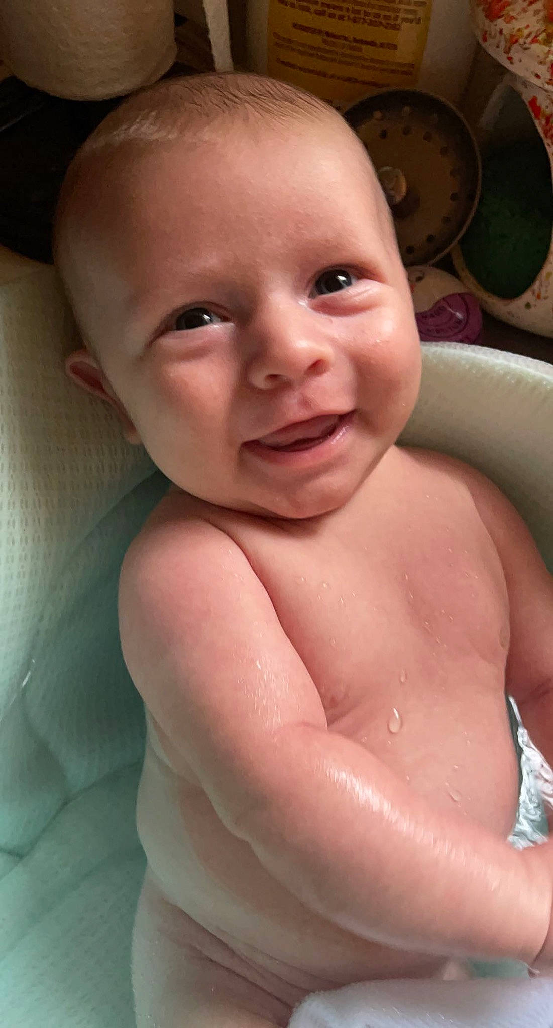Kade is registered to the contest to win money with this photo: baby, baby_bathing, cheek, chest, ear, eyebrow, eyelash, forehead, gesture, happy, human_body, iris, jaw, lip, mouth, neck, nose, person, skin, smile