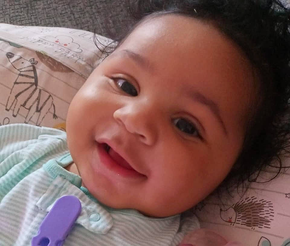 Sierra is registered to the contest to win money with this photo: baby, cheek, child, chin, eyebrow, eyelash, facial_expression, forehead, gesture, happy, iris, lip, mouth, nose, organ, person, pink, skin, smile, toddler