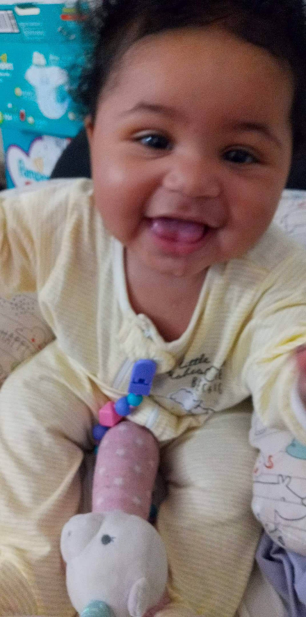 Sierra is registered to the contest to win money with this photo: arm, baby_toddler_clothing, cheek, dress, eye, eyebrow, face, finger, hand, head, human_body, iris, lip, mouth, neck, nose, organ, person, product, skin