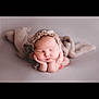 newborn, baby, infant, sleeping, portrait, cute, face, hands, bonnet, soft_texture, blanket, neutral_colors, peaceful, closeup, studio, resting, adorable, skin, headwear, young_child