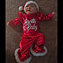 Kamrynn is registered to the contest to win money with this photo: baby, infant, red_clothing, santa_hat, christmas_outfit, carpet, holiday, festive, cute, lying_down, child, portrait, costume, indoor, smiling, face, person, fur_trim, holiday_season, celebration