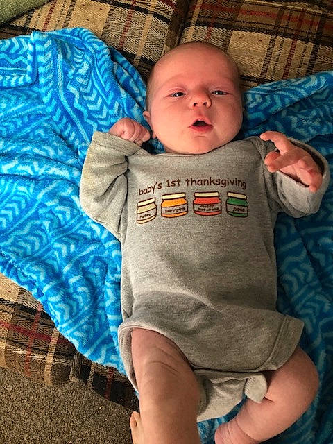Colby is registered to the contest to win money with this photo: arm, baby, baby_toddler_clothing, blue, cheek, child, comfort, couch, eye, finger, happy, head, iris, leg, mouth, nose, person, skin, sleeve, t_shirt