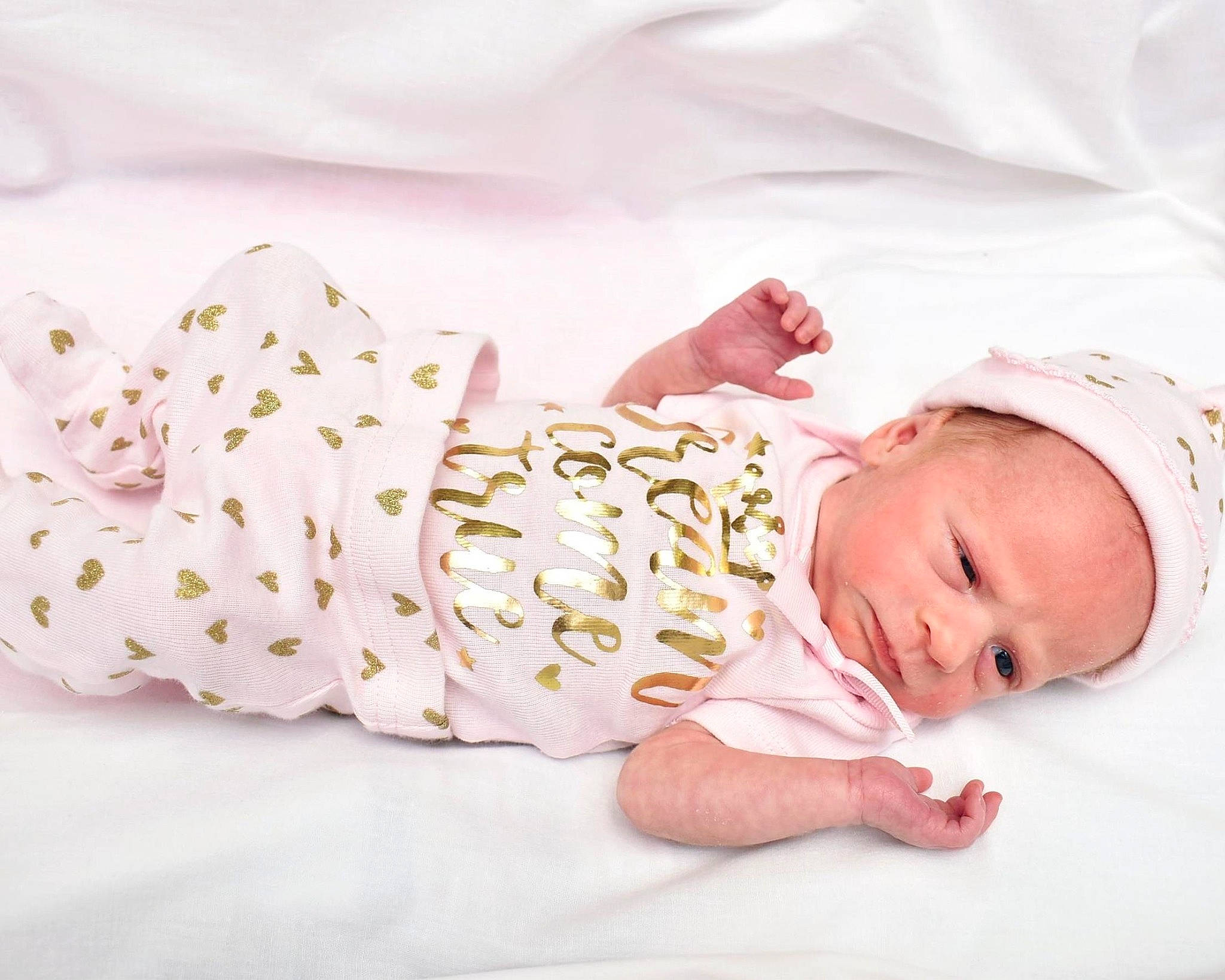 Molly is registered to the contest to win money with this photo: baby, baby_products, baby_sleeping, baby_toddler_clothing, bedding, bedtime, child, comfort, fashion_accessory, hand, happy, headgear, human_leg, linens, pattern, person, product, skin, sleeve, textile