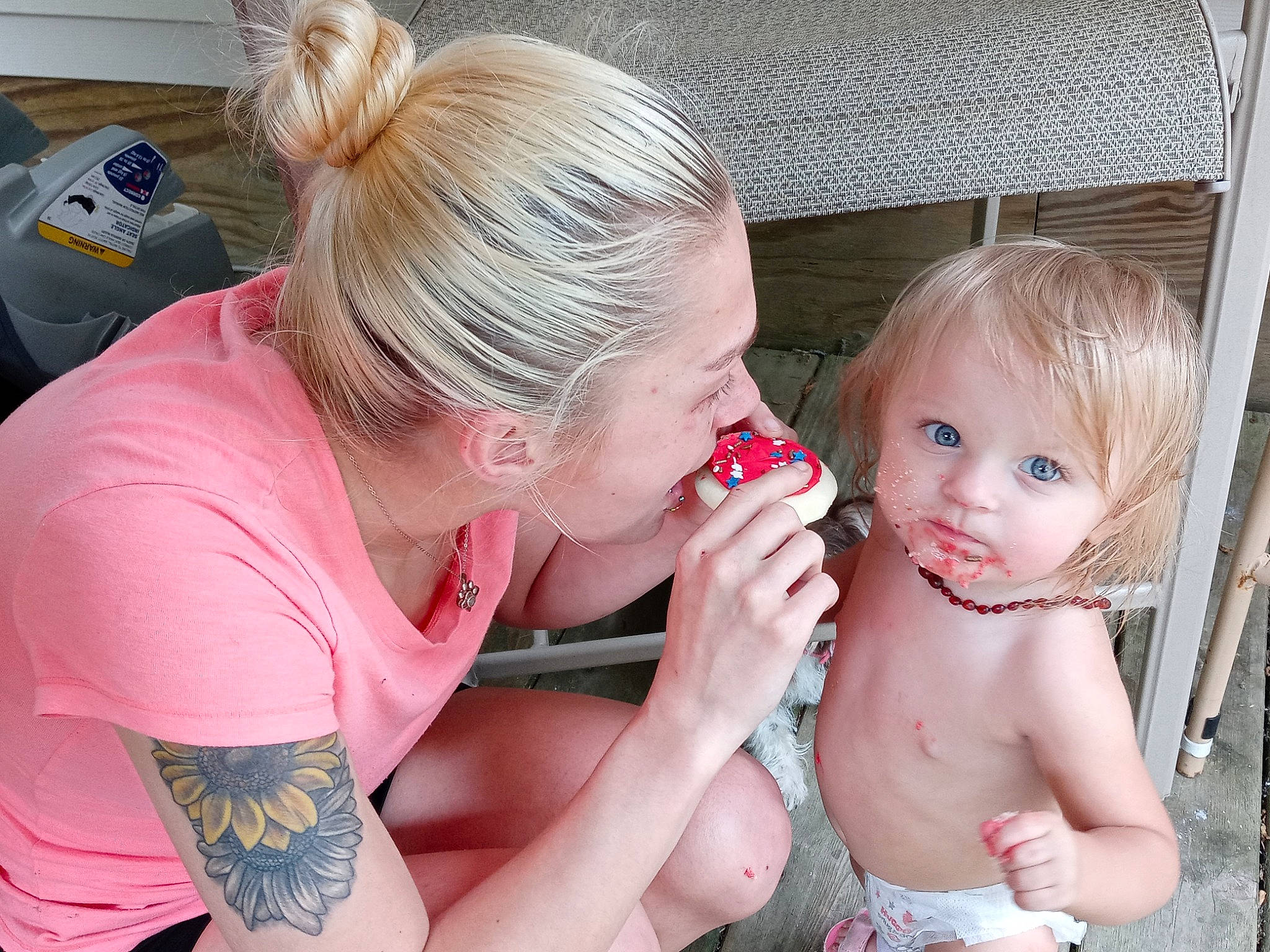 Molly is registered to the contest to win money with this photo: baby, blond, chest, chin, ear, event, eyelash, fun, gesture, hair, happy, jewellery, lip, mouth, necklace, person, pink, sitting, smile, tableware