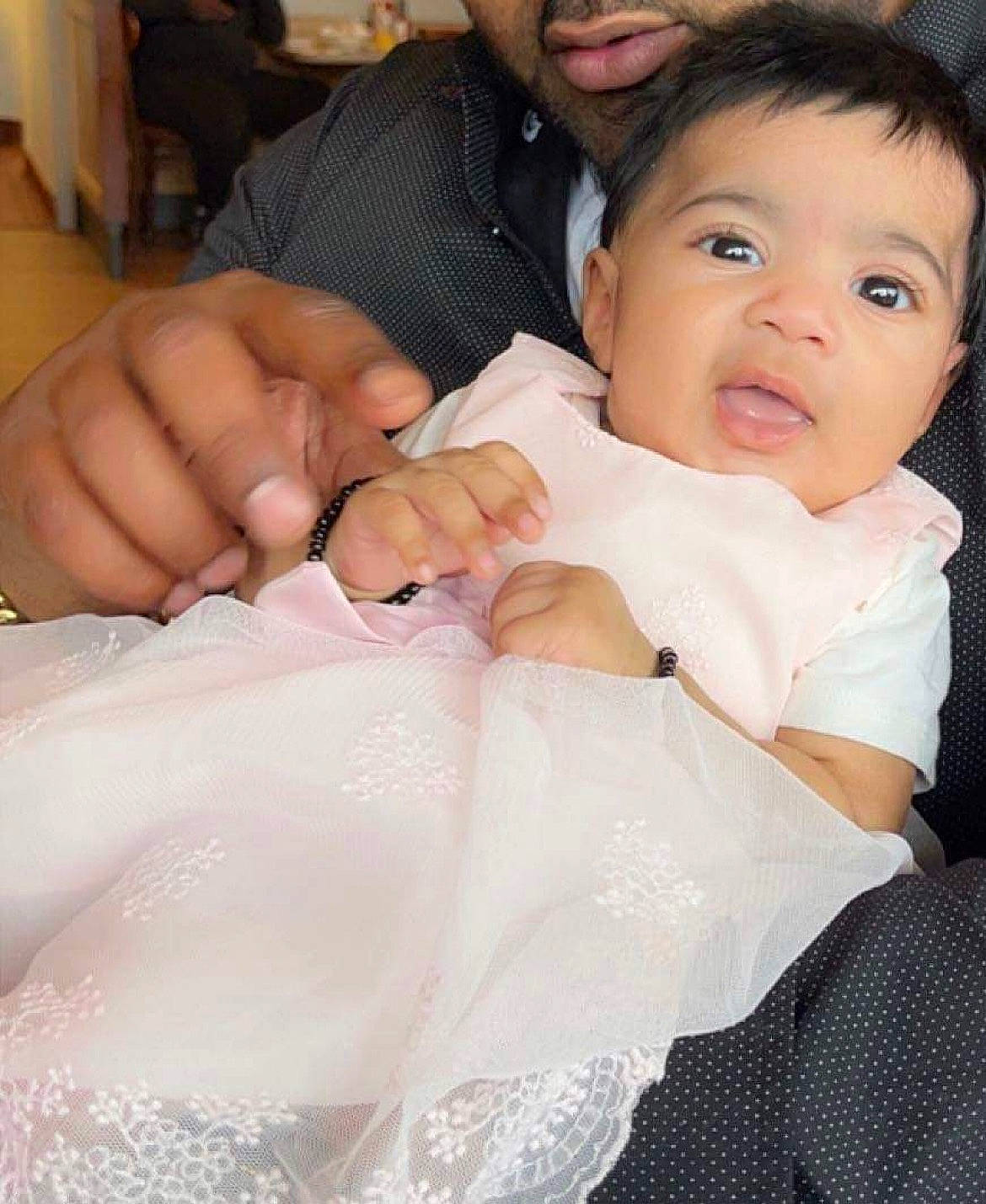 Naina is registered to the contest to win money with this photo: baby, baby_toddler_clothing, chair, child, event, fashion_accessory, finger, formal_wear, fun, gesture, happy, jewellery, lip, nail, person, sitting, skin, thumb, toddler, tradition