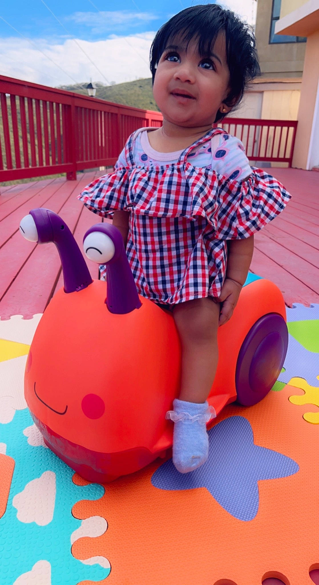 Naina joined the competition — help win amazing prizes! baby, baby_playing_with_toys, baby_toddler_clothing, child, electric_blue, facial_expression, fun, happy, leisure, organ, pattern, person, pink, recreation, riding_toy, shorts, sky, snapshot, t_shirt, toddler