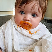 Bonnie joined the competition — help win amazing prizes! baby, blue_eyes, food_smear, white_cloth, bib, face, messy, close_up, indoor, child, curious, infant, messy_face, baby_food, cute, person, portrait, young_child, expression, sitting