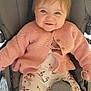 baby, button, child, clothing, comfort, cute, face, floral_pants, hair, happy, indoor, infant, pacifier, person, pink_cardigan, portrait, seat, smile, stroller, young_child