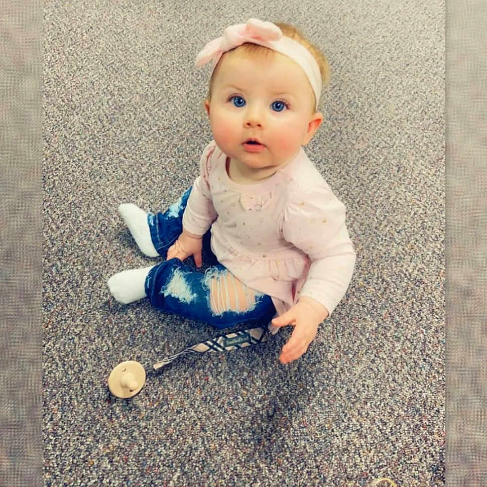 Halle is registered to the contest to win money with this photo: asphalt, baby, baby_products, baby_toys, child, doll, electric_blue, eye, floor, flooring, human_body, mammal, pattern, product, sitting, stuffed_toy, textile, toy, vertebrate, wood