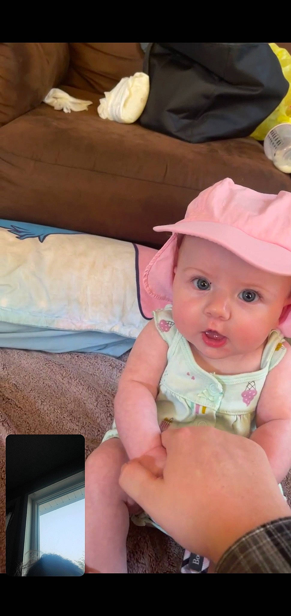 Halle joined the competition — help win amazing prizes! baby, baby_toddler_clothing, cap, cheek, child, comfort, eye, fun, happy, hat, head, headwear, human_body, iris, lip, person, pillow, sitting, skin, sun_hat