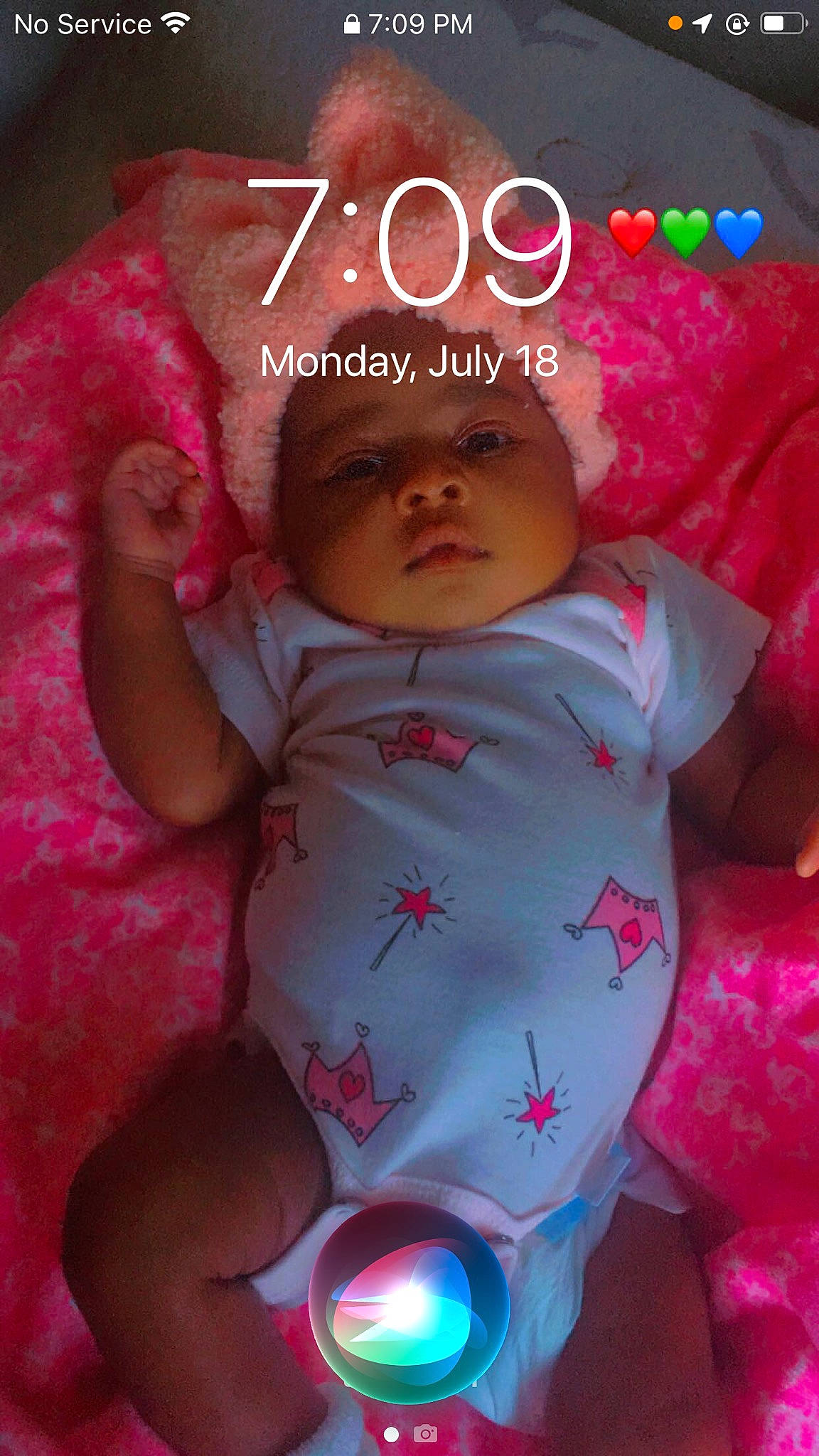 Legacy is registered to the contest to win money with this photo: baby, baby_products, baby_toddler_clothing, cheek, child, chin, eye, happy, head, headwear, human_body, linens, lip, magenta, pattern, person, photo_caption, pink, sitting, skin