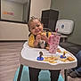 Katalina joined the competition — help win amazing prizes! toddler, child, high_chair, food, fries, chicken_nuggets, sippy_cup, pink_cup, yellow_shirt, smiling, indoor, flooring, window, reflection, furniture, person, happy, snack, cute, baby