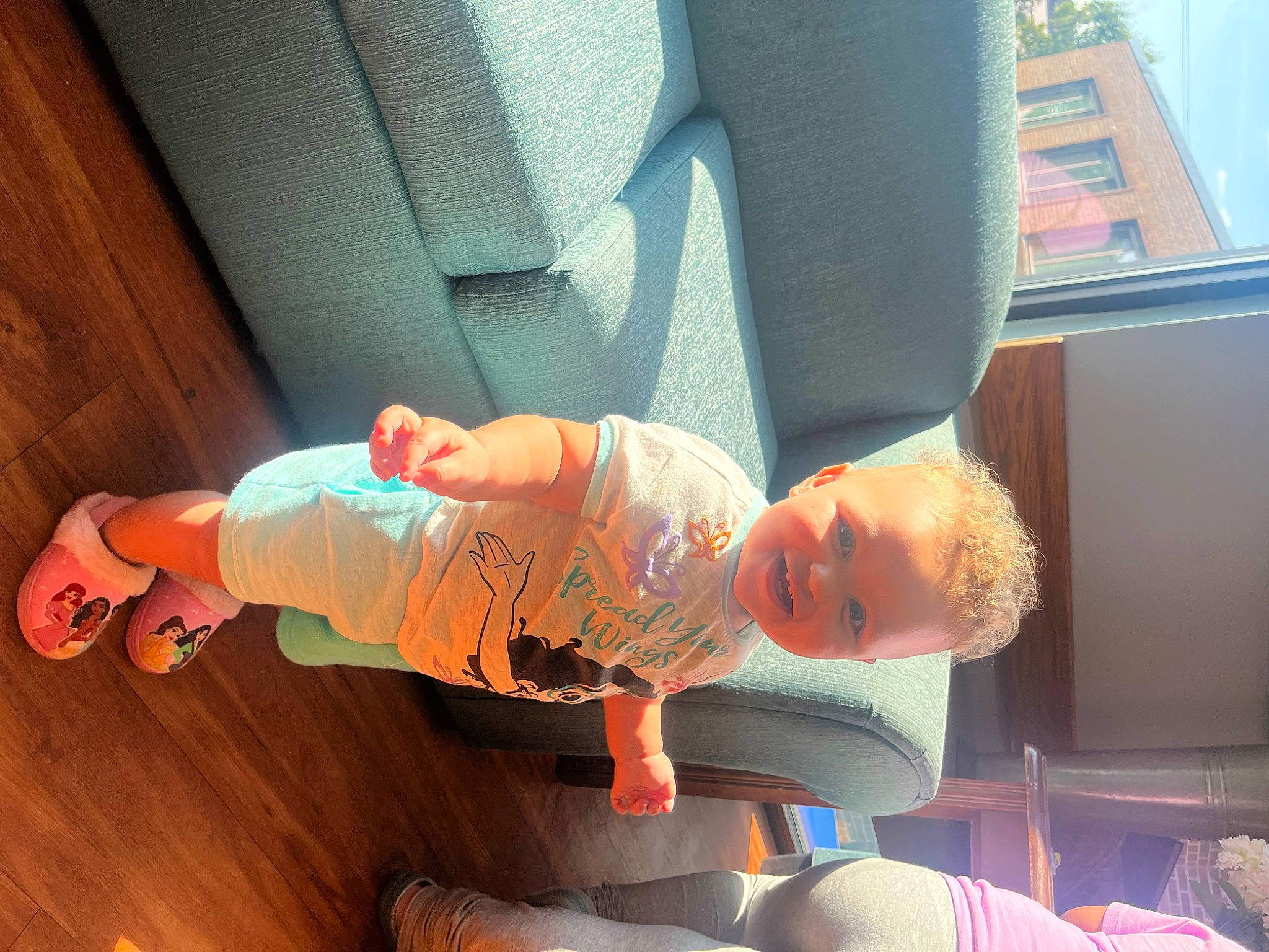 Ellianna is registered to the contest to win money with this photo: baby, baby_products, baby_toddler_clothing, car_seat, child, comfort, elbow, finger, fun, happy, hardwood, human_leg, knee, leisure, orange, person, room, sitting, t_shirt, toddler