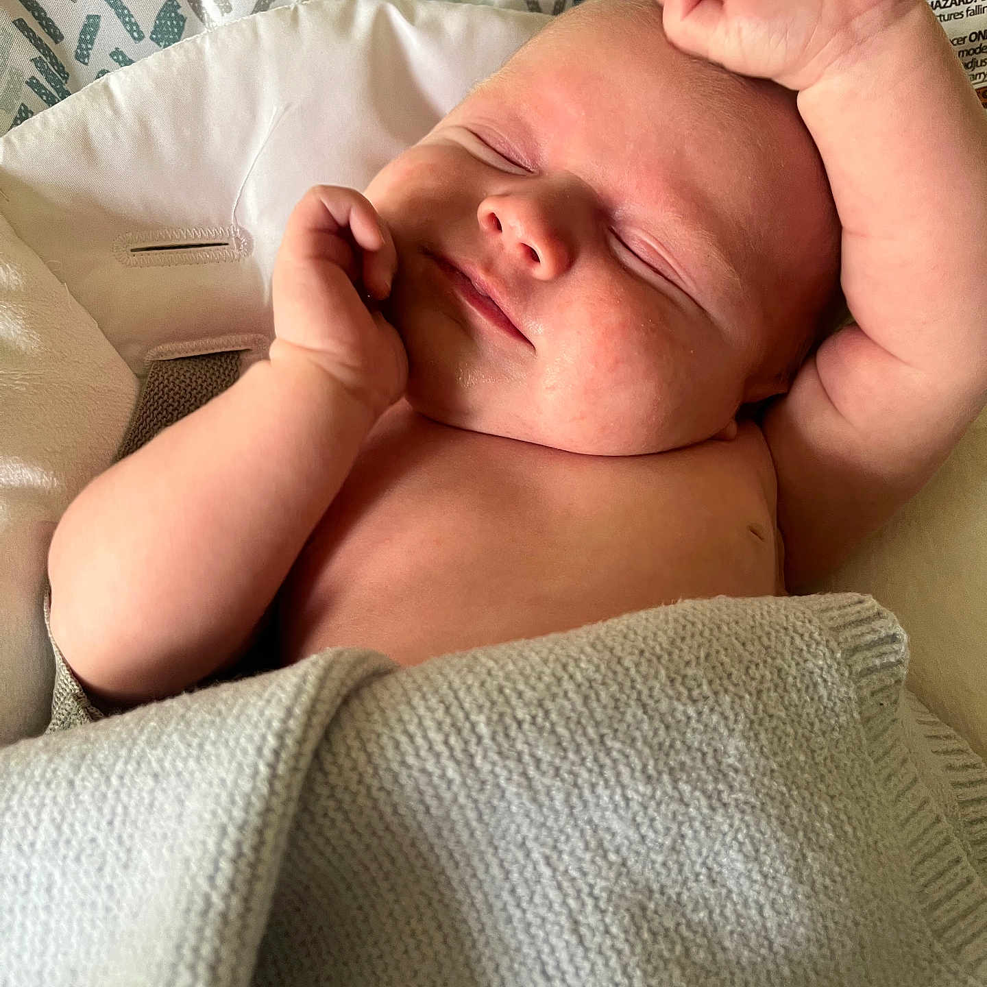 Thaddeus is registered to the contest to win money with this photo: arm, baby, blanket, closeup, comfort, cushion, fabric, face, hand, indoors, infant, knitted, newborn, patterned, peaceful, portrait, resting, skin, sleeping, soft