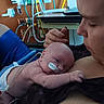 baby, newborn, hospital, medical_equipment, nasal_tube, adult, care, love, skin, intimate, resting, person, closeup, healthcare, mother, infant, tenderness, bedside, emotion, support