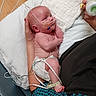 baby, infant, hospital, medical_tubes, diaper, adult_hand, bottle, bed, blanket, sensor_wires, patient, care, healthcare, newborn, person, medical_care, lying_down, hospital_room, cute, tender_moment