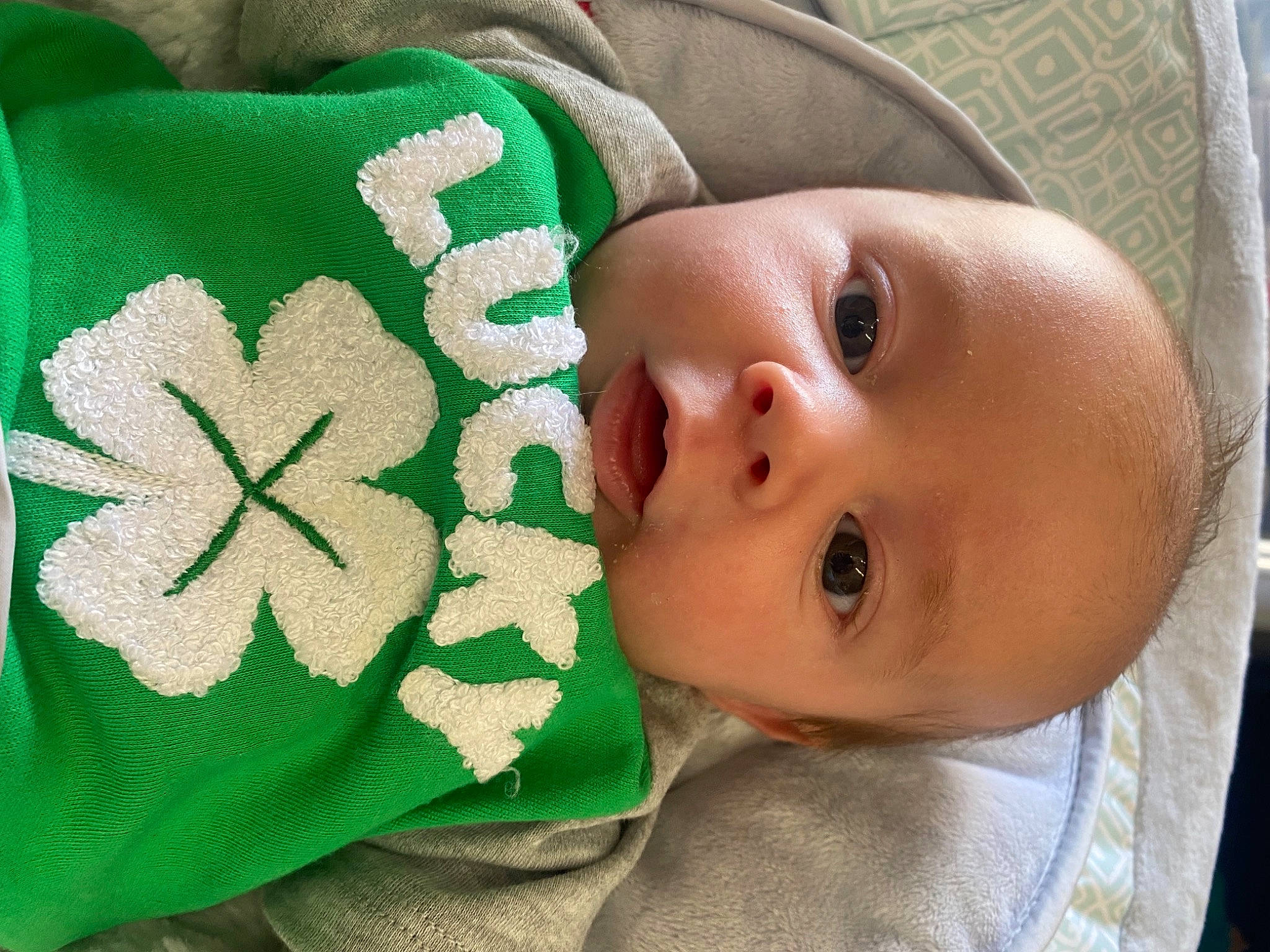 Kash is registered to the contest to win money with this photo: baby, baby_toddler_clothing, beauty, cheek, close_up, comfort, face, finger, green, happy, headgear, linens, lip, nose, person, plant, product, skin, sleeve, textile