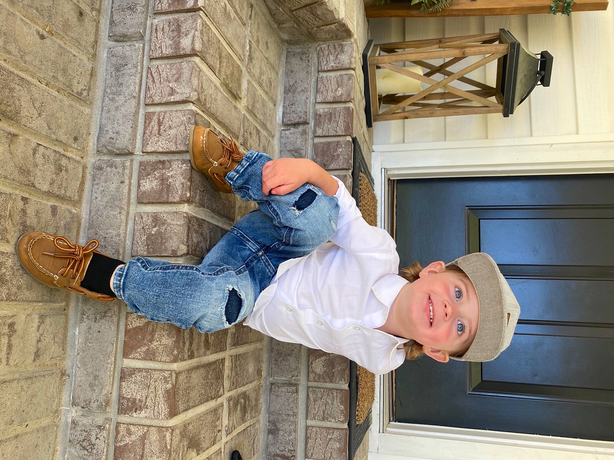 Kasen is registered to the contest to win money with this photo: cabinetry, denim, flooring, happy, hat, headwear, home_appliance, human_leg, joy, kitchen, kitchen_appliance, leg, person, plant, refrigerator, room, shoe, sitting, street_fashion, sunglasses