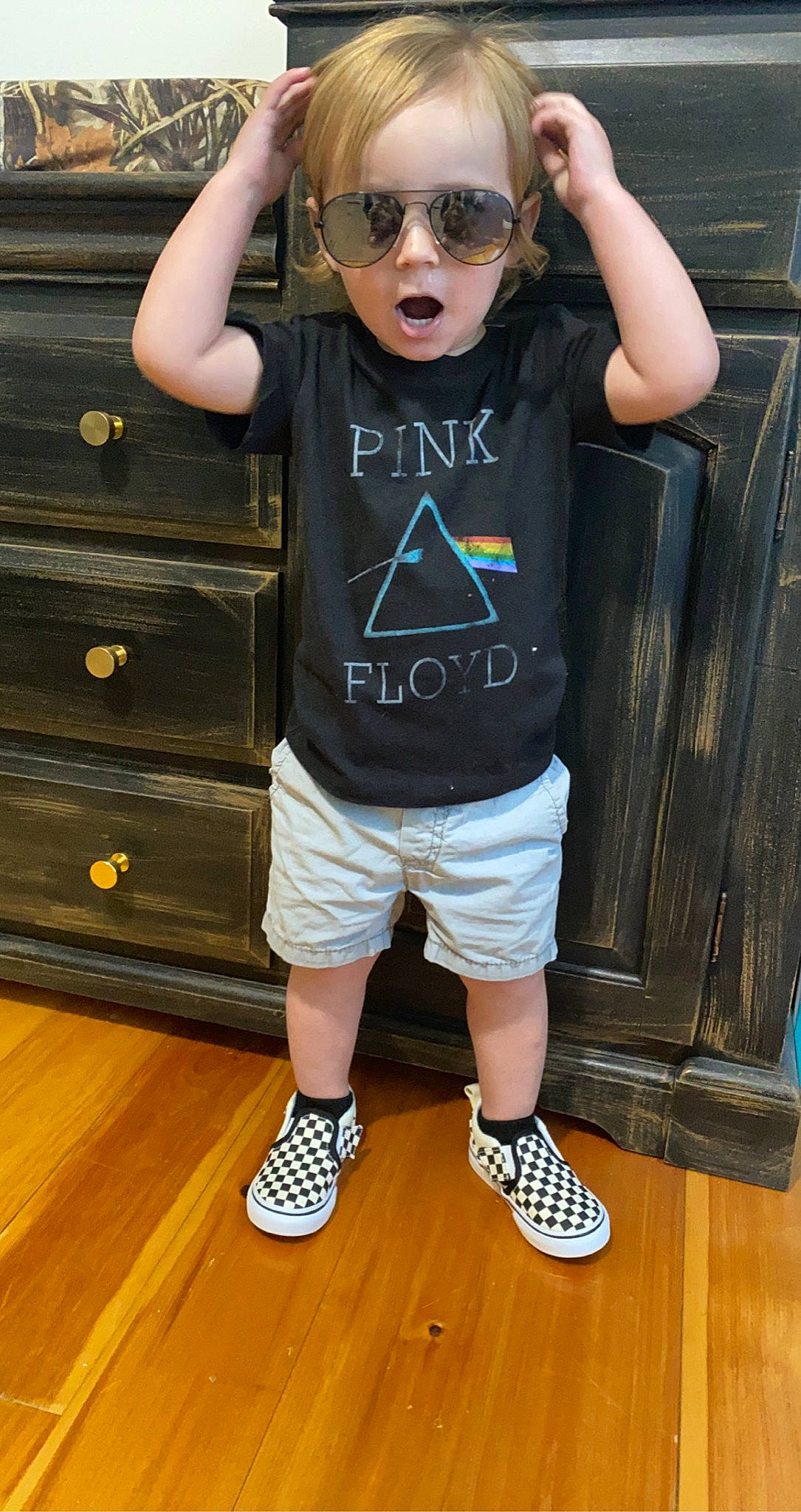 Kasen is registered to the contest to win money with this photo: cabinetry, cool, eyewear, glasses, goggles, muscle, person, shoe, shorts, sleeve, sneakers, standing, street_fashion, sunglasses, t_shirt, thigh, vision_care, waist, white, wood