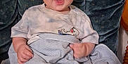 Jasper is registered to the contest to win money with this photo: baby, infant, child, smile, happy, sitting, blanket, clothing, tshirt, foot, feet, face, expression, chair, cushion, indoor, cute, young, comfort, portrait