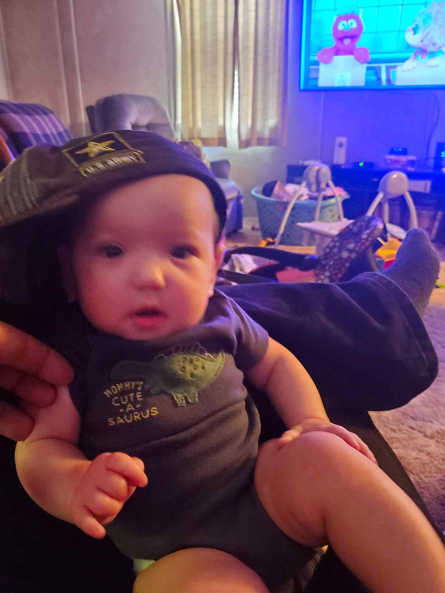 Isabella is registered to the contest to win money with this photo: baby, beauty, blue, cap, cool, curtain, finger, fun, hand, happy, hat, leg, light, lighting, person, purple, television, thigh, thumb, toddler