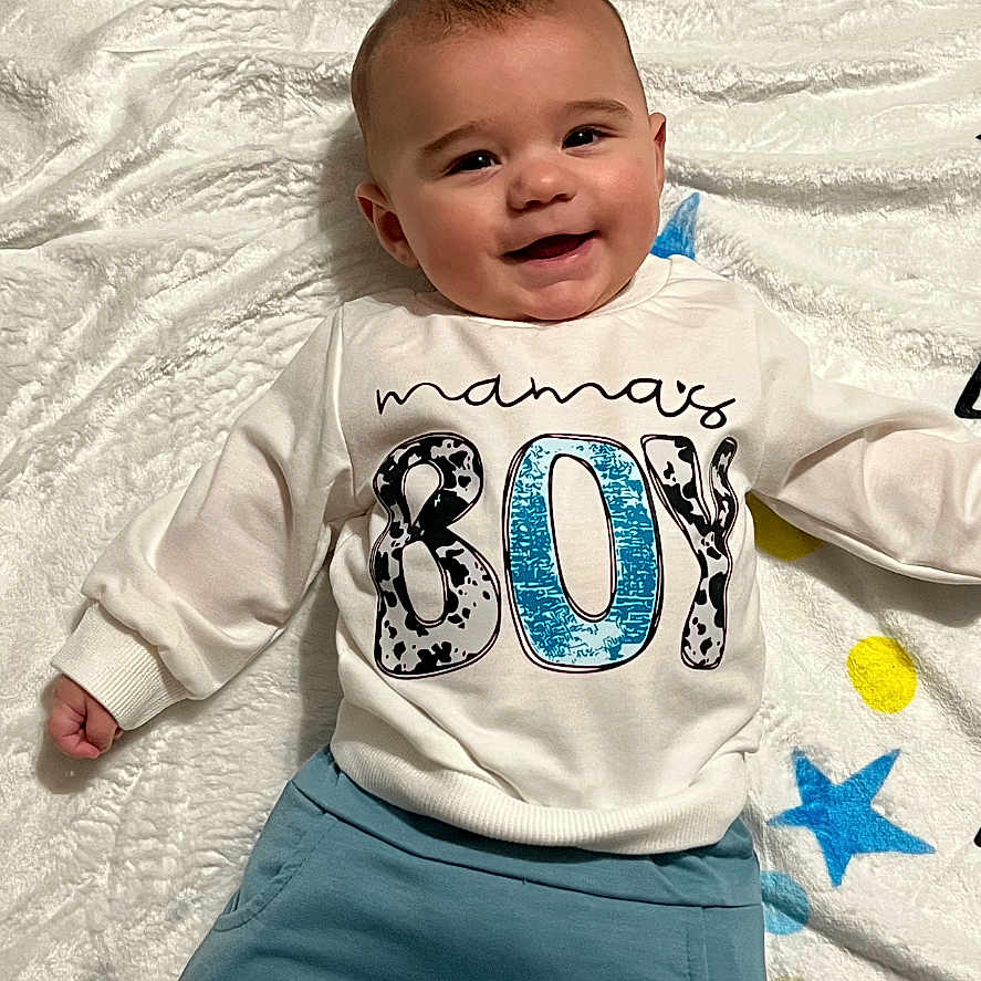 Camaro is registered to the contest to win money with this photo: baby, babylaughing, bodypart, clothing, face, finger, hand, happy, head, jeans, longsleeve, newborn, pants, person, photography, portrait, shirt, sleeve, t_shirt, text