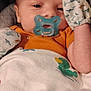 Nathaniel is registered to the contest to win money with this photo: baby, pacifier, mittens, blanket, duck_print, dinosaur_pattern, infant, cute, face, portrait, child, cozy, clothing, seated, indoors, closeup, expression, resting, newborn, comfort