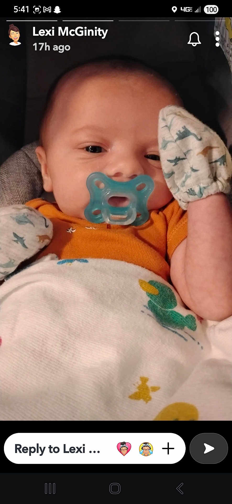 Nathaniel is registered to the contest to win money with this photo: baby, pacifier, mittens, blanket, duck_print, dinosaur_pattern, infant, cute, face, portrait, child, cozy, clothing, seated, indoors, closeup, expression, resting, newborn, comfort