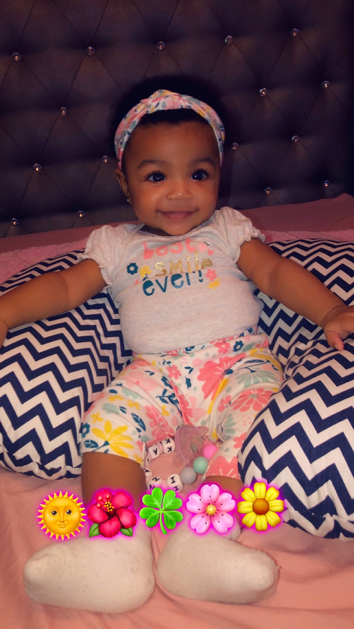 Kalani is registered to the contest to win money with this photo: baby, baby_toddler_clothing, cheek, child, hair_accessory, joy, person, pink, sitting, skin, toddler