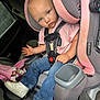 baby, blanket, car_interior, car_seat, child, clothing, curious, infant, jeans, person, pink_shirt, safety_harness, seat, seat_cushion, seatbelt, toddler, transportation, vehicle, white_shoes, window