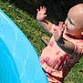 Oaklynn joined the competition — help win amazing prizes! baby, bare_head, blue_pool, child, daylight, fun, grass, happy, outdoor, pink_clothing, playtime, pool, raising_hands, short_sleeves, side_profile, smiling, summer, sunny, toddler, water_play